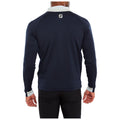 A person is wearing a navy blue long-sleeve shirt with a white collar and cuffs facing away from the viewer in a neutral setting