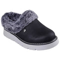 A black slip-on shoe with a fuzzy gray collar rests on a white surface showcasing its comfortable design and soft lining ideal for casual wear in relaxed environments.