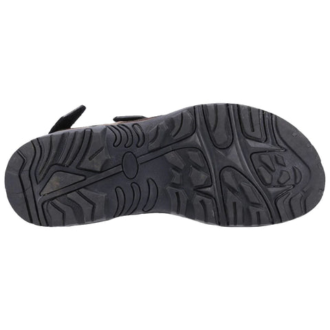 A shoe sole is displayed resting on a flat surface showcasing its textured tread designed for grip and support highlighting various patterns for traction during walking or outdoor activities.