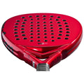 A red paddle racket with a perforated surface rests in a horizontal position showcasing its sleek design and grip area ideal for racket sports.