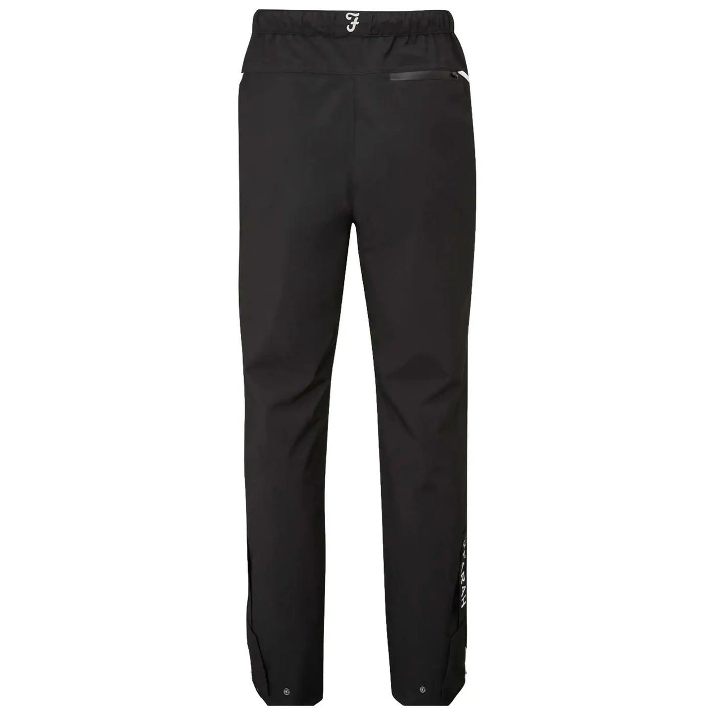 Black waterproof pants stand upright showcasing an elastic waistband and side zippered pocket with a reflective logo above the waistband providing a sleek design suitable for outdoor activities.