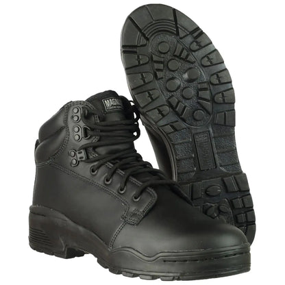 Black combat boots are positioned upright with laces tightened while the soles display a rugged tread pattern set against a plain white background emphasizing their sturdy construction and practical design.