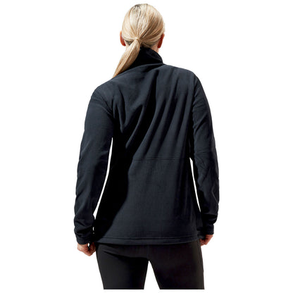 A person is facing away wearing a black fleece jacket and black pants in a simple white background, showcasing the garment's texture and design without distractions from other elements.