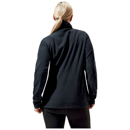 A person is facing away wearing a black fleece jacket and black pants in a simple white background, showcasing the garment's texture and design without distractions from other elements.