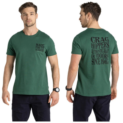 A man wearing a green t-shirt stands facing both front and back with arm relaxed displaying text on the shirt. The front text reads MADE FOR THE OUTDOORS and the back text reads CRAG HOPPERS AUTHENTICALLY OUTDOORS SINCE 1963. He also wears a watch on his left wrist.