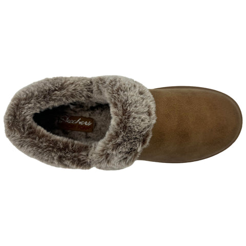 A brown slipper is displayed from above featuring a soft faux fur cuff at the opening and a smooth surface on the body with branding visible inside the shoe