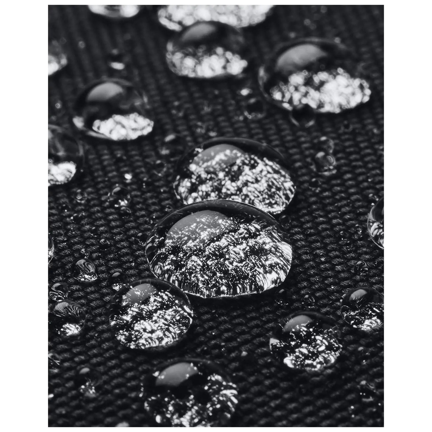 Water droplets rest on a textured black surface reflecting light while appearing clear and glossy in a close-up view showcasing the contrast between the droplets and the background.