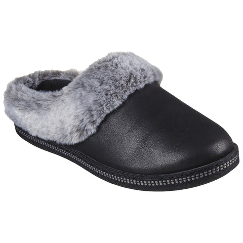 A black slipper with a gray fur collar is positioned at an angle revealing its soft surface and rounded toe designed for comfort and casual indoor wear