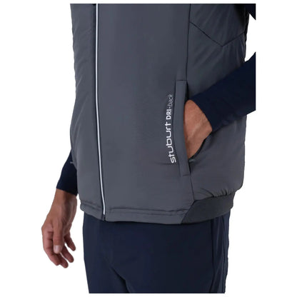 A gray puffer vest is being worn by a person whose hand is placed in a side pocket while they stand in a neutral environment