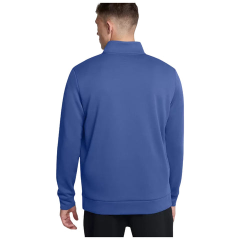 A person is standing with their back facing the viewer, wearing a blue pullover sweatshirt in a neutral background setting, suggesting a casual and relaxed environment.