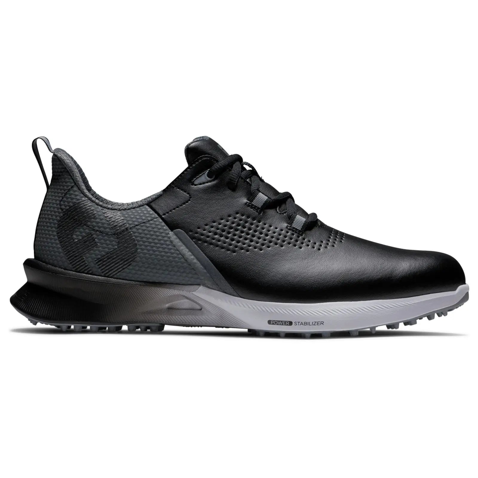A black athletic shoe with a textured surface and a gray outsole sits on a flat surface showcasing its sleek design and lacing system meant for comfort and performance.