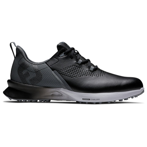 A black athletic shoe with a textured surface and a gray outsole sits on a flat surface showcasing its sleek design and lacing system meant for comfort and performance.