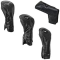 Four golf club headcovers are displayed in black and green leather materials showcasing a sleek design each featuring a logo and varying shapes positioned against a plain background.