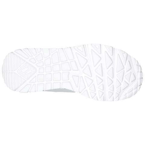 A white shoe sole features a patterned grip with geometric shapes designed for traction. It is isolated against a plain background emphasizing the shoe's design and functionality.