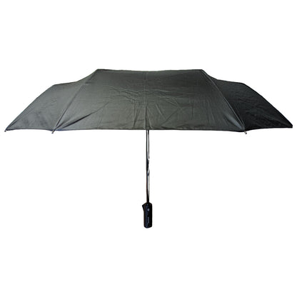 A dark umbrella stands upright featuring a metal pole and a black handle designed for outdoor use providing shelter from rain or sun in an open space.