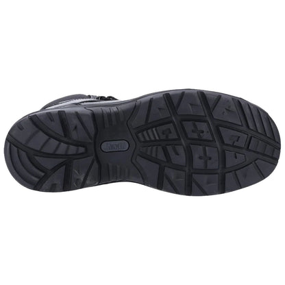 A black shoe sole is displayed flat on a surface showcasing a rugged tread pattern designed for traction in various environments indicating durability and functionality