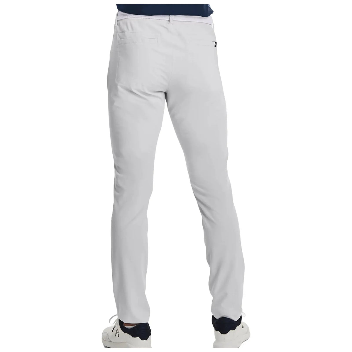 Light-colored pants are being worn by a person standing with their back facing the viewer in a neutral indoor setting. The person is also wearing white shoes.