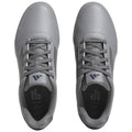 Gray athletic shoes are displayed from a top view with laces tightly secured featuring a sleek design and a message inside the shoe that reads END PLASTIC WASTE