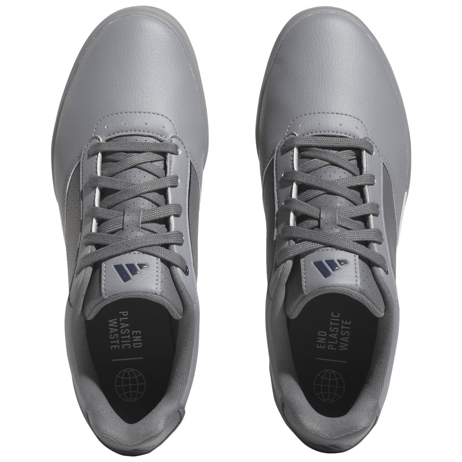 Gray athletic shoes are displayed from a top view with laces tightly secured featuring a sleek design and a message inside the shoe that reads END PLASTIC WASTE