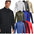 A young man stands wearing a black zip-up pullover next to a display of various colored sweatshirts including white gray green blue red and maroon in a clothing retail context.