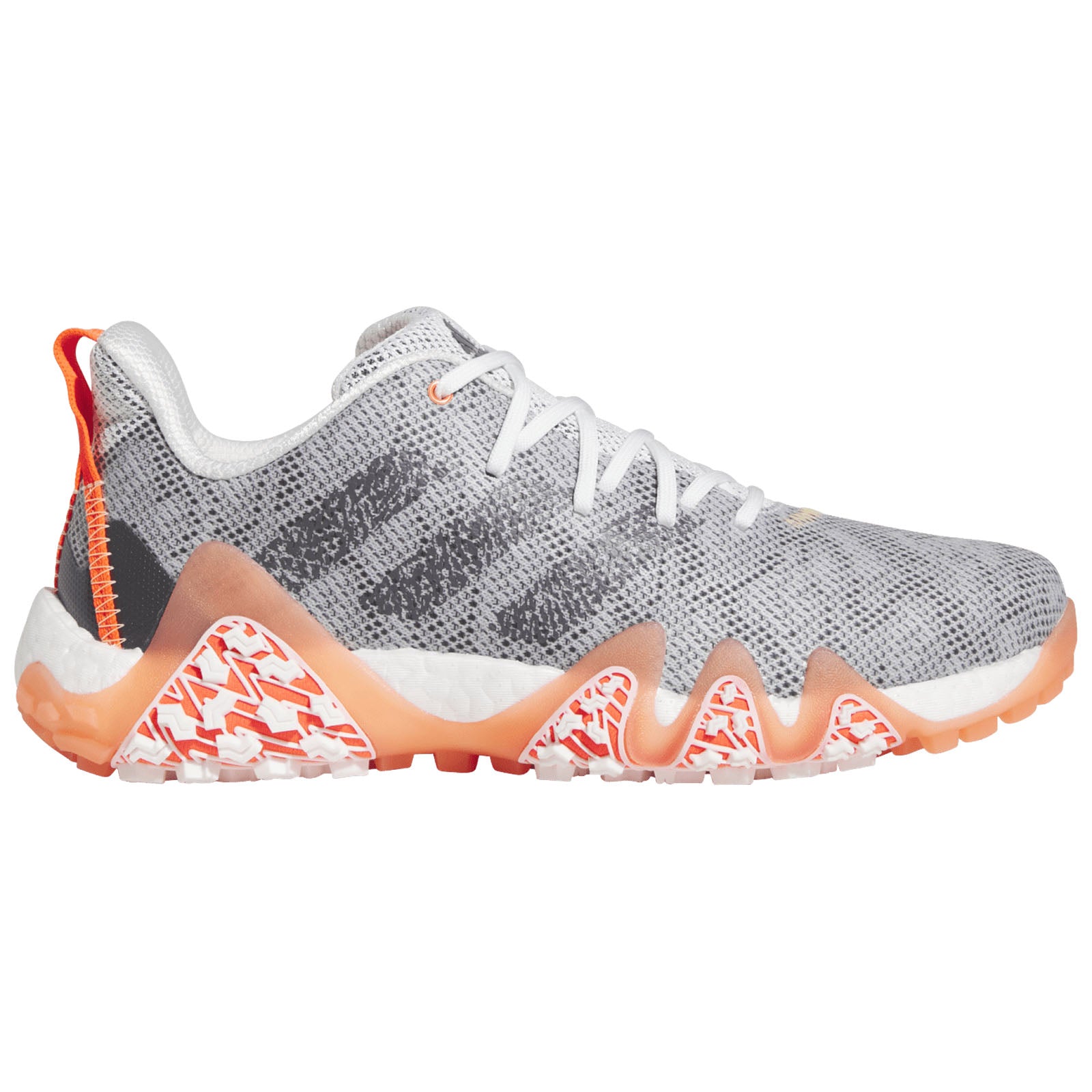 A grey athletic shoe with orange and white accents features a textured upper and a distinctively shaped sole designed for performance in active environments such as gyms or outdoor sports.
