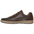 A brown leather sneaker rests flat with brown laces and a textured rubber sole the sneaker's design is casual and stylish suitable for various informal settings