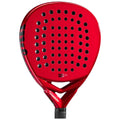 A bright red padel racket with a perforated surface and a triangular frame is displayed against a neutral background highlighting its sleek design and grip texture.