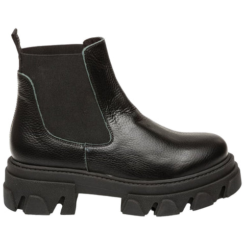 A black chelsea boot made of textured leather features elastic sides and a thick lug sole suitable for rugged terrain set against a plain background highlighting its design and materials.