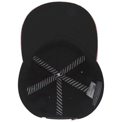 A black baseball cap with a pink brim lies on a flat surface showcasing its interior structure including black fabric and striped stitching lines with a circular button at the top.