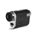 A compact digital device designed for zooming captures distant subjects displaying a sleek black and silver design with visible buttons and branding in a minimalist environment.