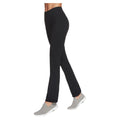 Black pants are being worn by a person walking in gray slip-on shoes in a neutral background, emphasizing the sleek look and comfortable style of the outfit.
