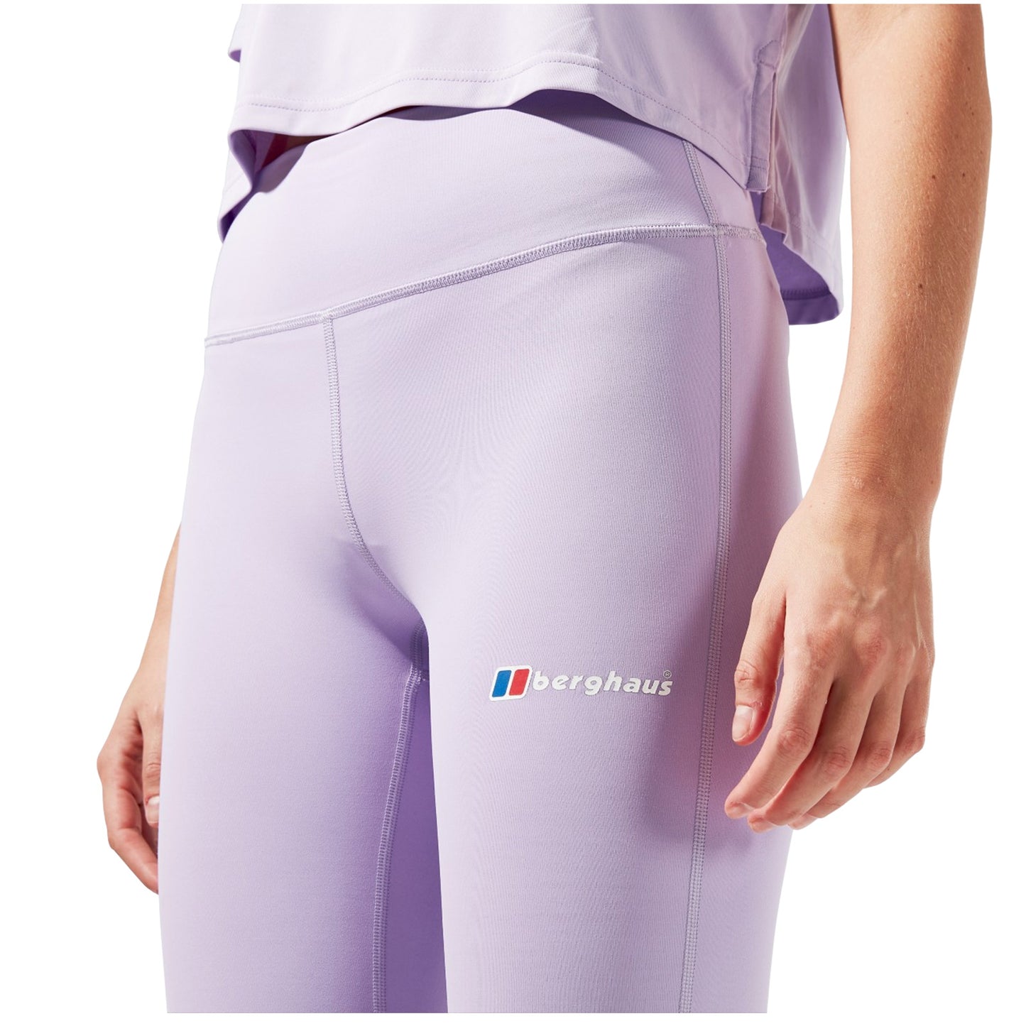 A person is wearing fitted lavender leggings. The leggings feature the logo of the brand Berghaus. The setting is likely casual or athletic, emphasizing comfort and style.