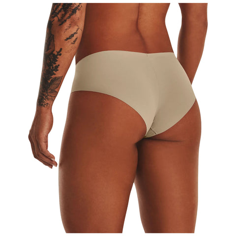 A person stands with their back facing the viewer wearing beige underwear showcasing a smooth skin tone and intricate tattoo details on their arm in a neutral background.