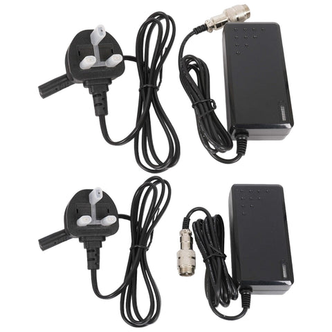 Two black power adapters are displayed with attached cables and plugs. They provide connectivity for electronic devices in a home or office environment. The adapters feature indicator lights and various connectors.