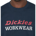 A navy blue t-shirt displays the text "Dickies WORKWEAR" prominently on the front with the word "Dickies" in red and "WORKWEAR" in white against a simple background.