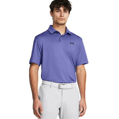 A young man stands confidently wearing a purple polo shirt and light-colored trousers with a belt showcasing a sporty and casual style suitable for outdoor activities.