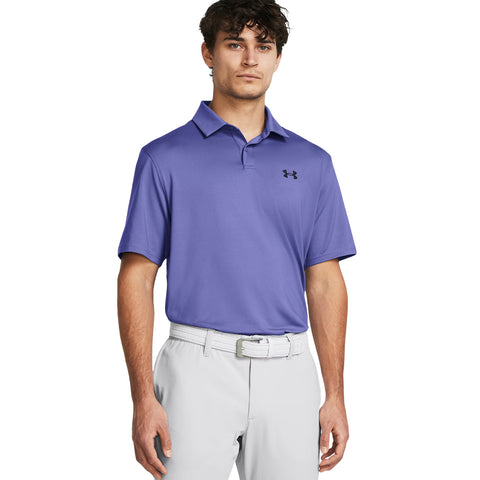 A young man stands confidently wearing a purple polo shirt and light-colored trousers with a belt showcasing a sporty and casual style suitable for outdoor activities.