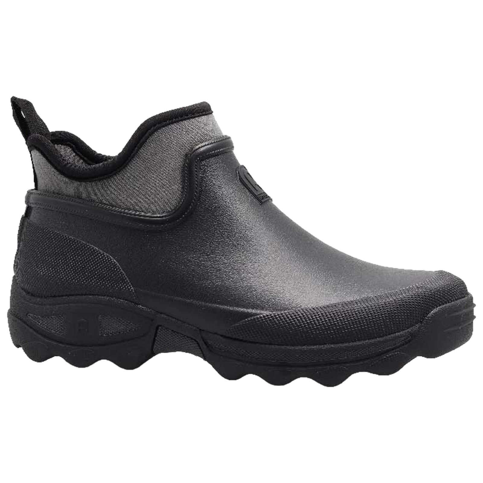 A black ankle boot is displayed standing upright its smooth surface shows a textured sole and a back pull tab for easy wear designed for comfort and practicality in outdoor settings