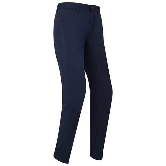 Navy blue pants are displayed standing upright showcasing a modern fit and flat front design in a plain setting with no distinctive background elements or accessories present