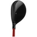 A black golf club head with a sleek design and a carbon fiber texture is positioned prominently against a white background showcasing its polished surface and distinctive branding elements.