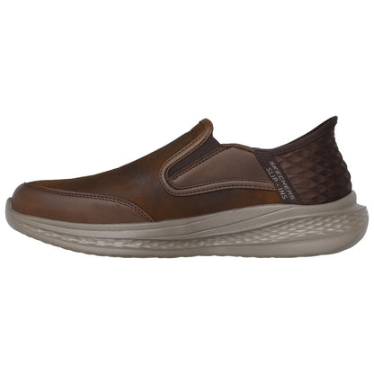 A brown slip-on shoe rests sideways showcasing a smooth leather upper with elastic panels for easy wear and a cushioned sole designed for comfort in casual settings.