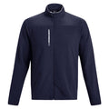 A navy blue jacket is hanging upright showcasing its full zip front and high collar with the brand name prominently displayed on the chest in white text.