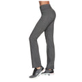 Gray athletic pants are worn by a person standing sideways wearing black sneakers in a neutral background showcasing a fit silhouette designed for comfort and performance.