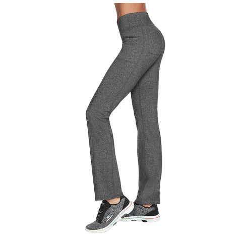 Gray athletic pants are worn by a person standing sideways wearing black sneakers in a neutral background showcasing a fit silhouette designed for comfort and performance.