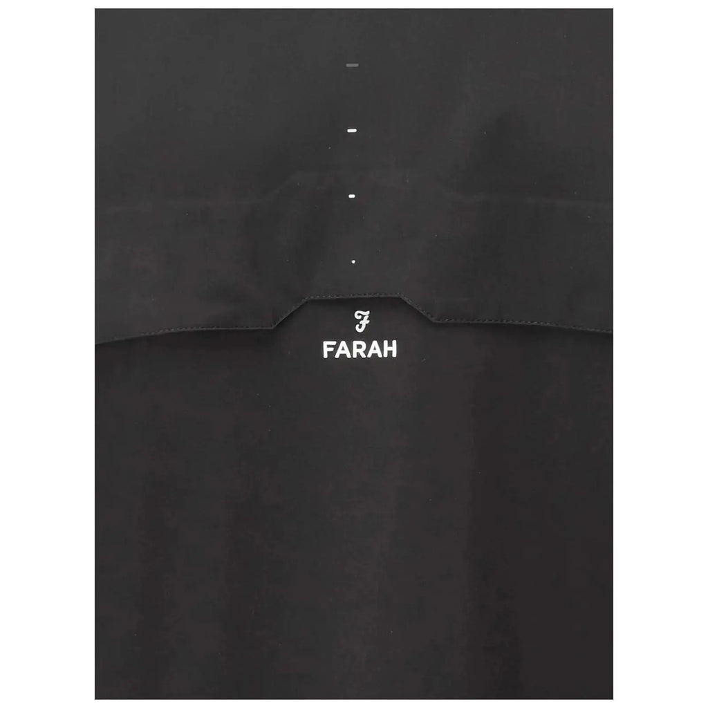 A black garment featuring a small logo and the word FARAH prominently displayed beneath it highlights simple design in a sleek and minimalistic context.