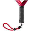 A red and black paddle is shown with a textured handle and a red wrist strap attached, designed for use in water sports or activities on a plain background.