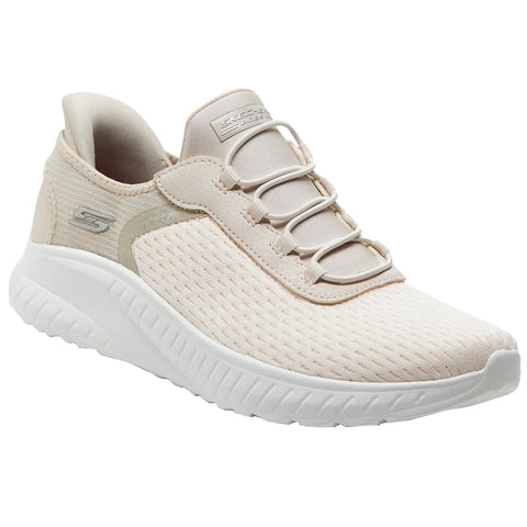 A beige sneaker with a textured upper features elastic laces and a cushioned sole designed for comfort and support in casual or athletic settings. Background is plain white.
