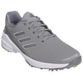 A gray golf shoe with a textured upper is positioned prominently featuring lace detailing and three stripes on the side set against a plain white background.