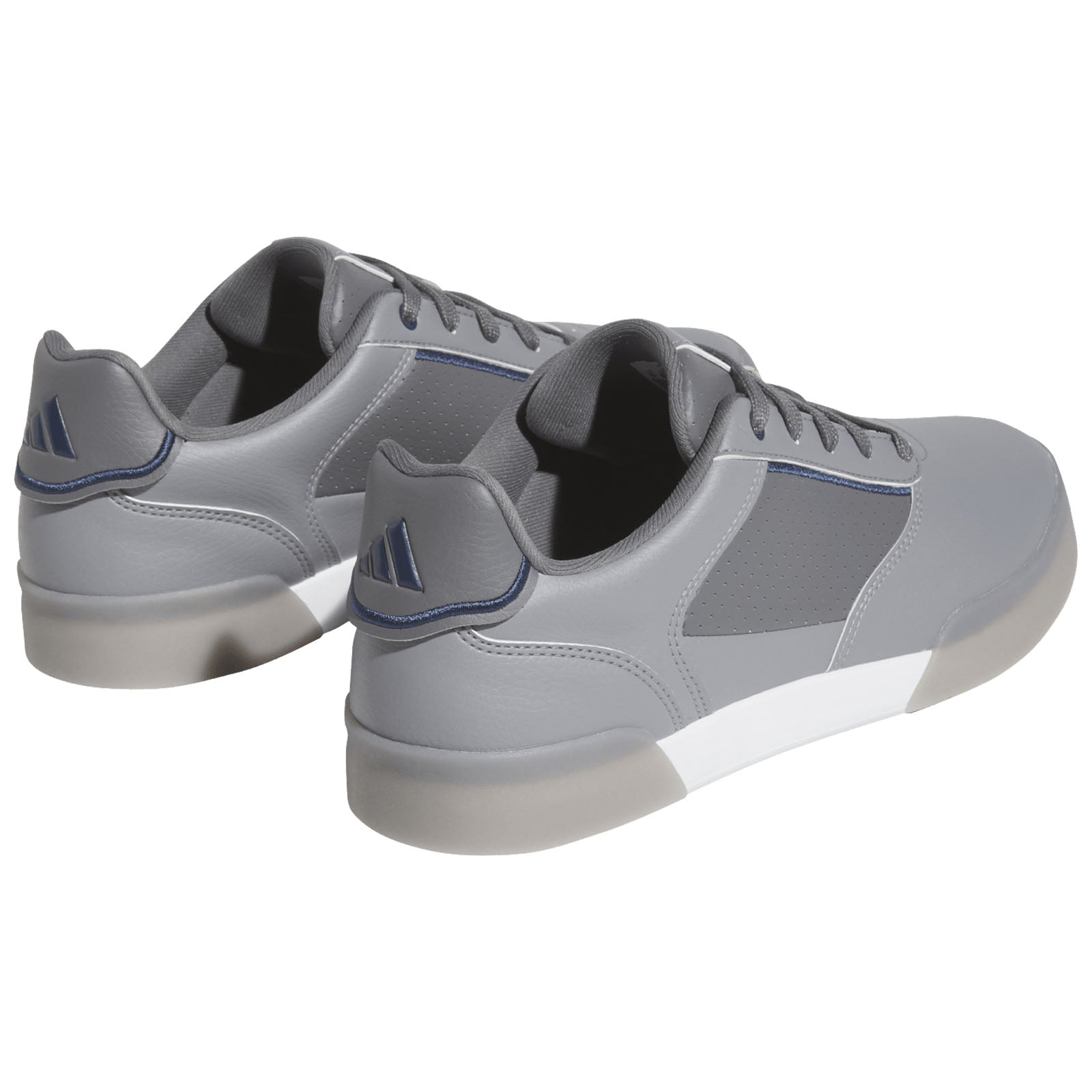 Gray athletic shoes are positioned to show the back and side. They feature a sleek design with a smooth finish and subtle detailing, set against a plain white background.