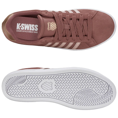 A pair of brown sneakers with a suede texture features white stripes and a branded insole. Positioned flat with an emphasis on their design and details against a plain backdrop.
